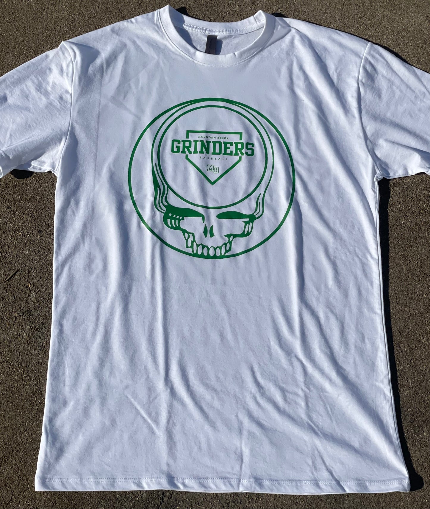 Team Green - Grinders logo in the deadhead. It comes in white and green short sleeve options.